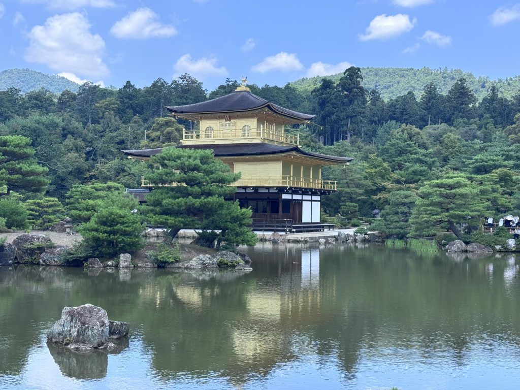 Kinkaku-ji’s Golden Pavilion reflected in the pond, surrounded by trees