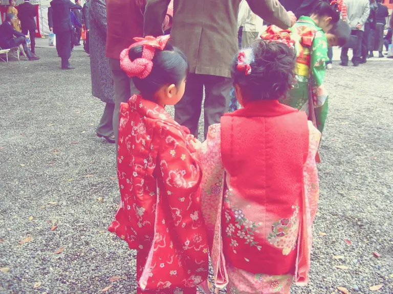 Child in a pink kimono walking at a shrine during Shichi-Go-San