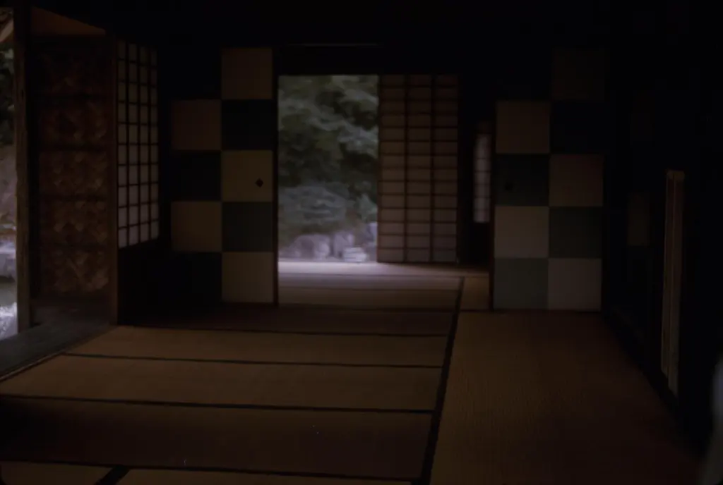 Open interior of Shōkin-tei with tatami, posts, screens, and a framed garden view