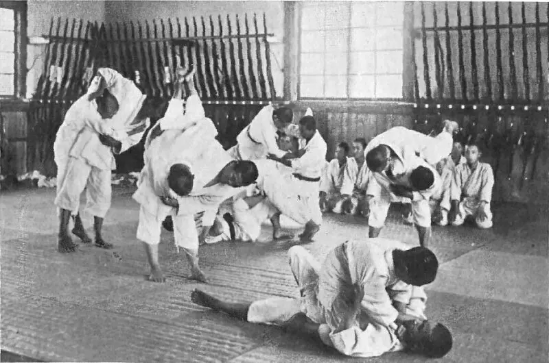 Historical photograph of students practising Jujutsu outdoors at an agricultural school