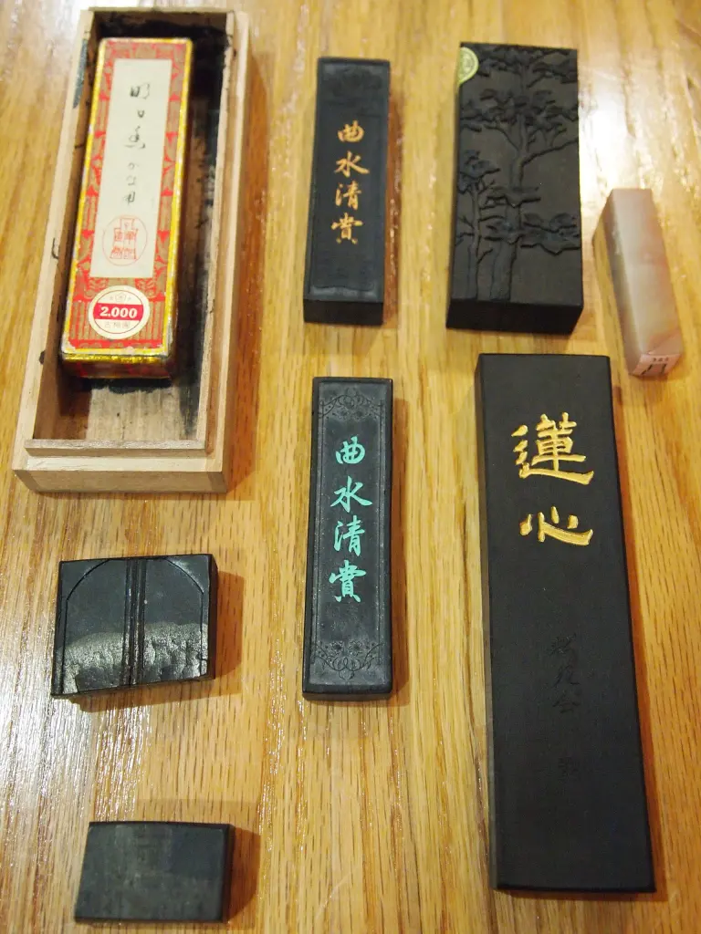 Several decorated Japanese calligraphy inksticks arranged together