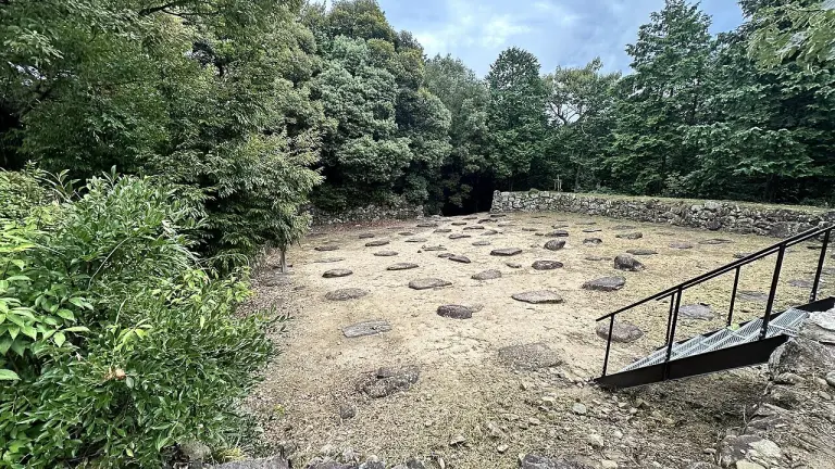 Stone foundations and wooded surroundings at the ruins of Azuchi Castle.