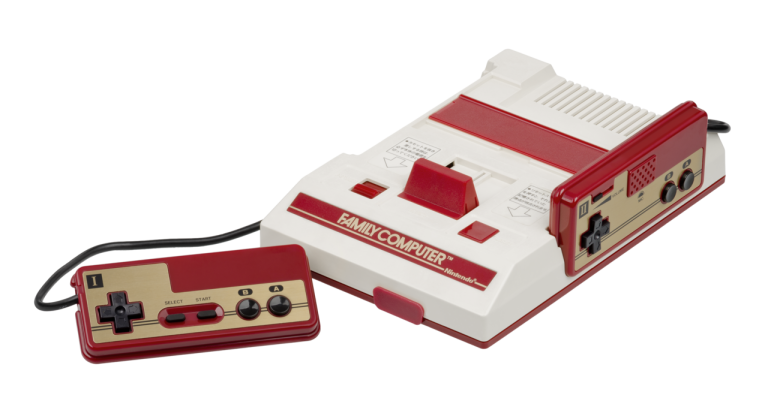 A Nintendo Famicom console with two red-and-gold wired controllers.