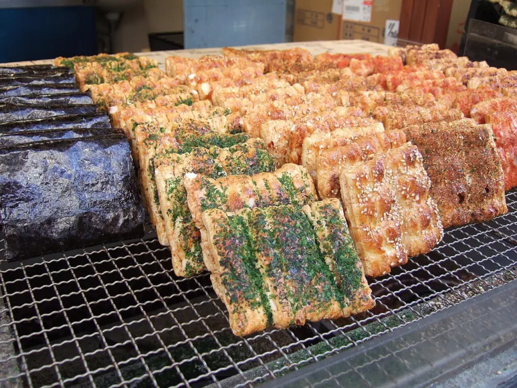 An assortment of senbei with different shapes and seasonings.
