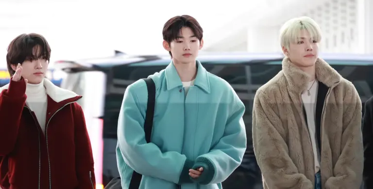 Yuma, Jo and Maki, three members of &TEAM, walk through Incheon Airport in winter clothing