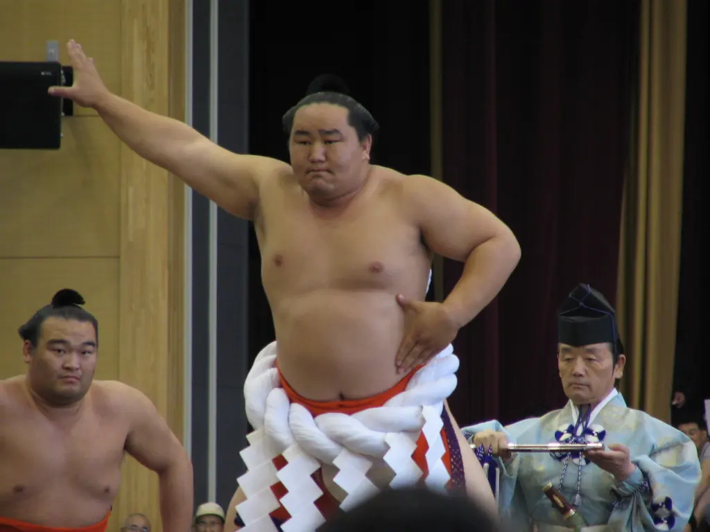 Asashōryū in a white ceremonial rope performing a ring-entering movement.
