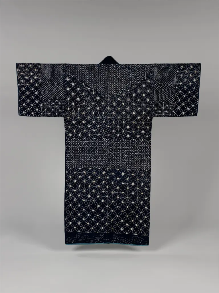 Indigo sashiko jacket covered with white running-stitch patterns