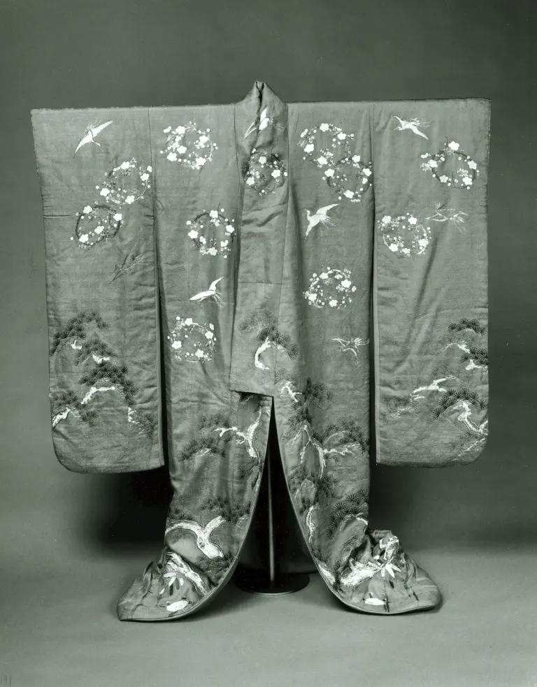 Front view of a red-orange nineteenth-century furisode with long sleeves and embroidered decoration