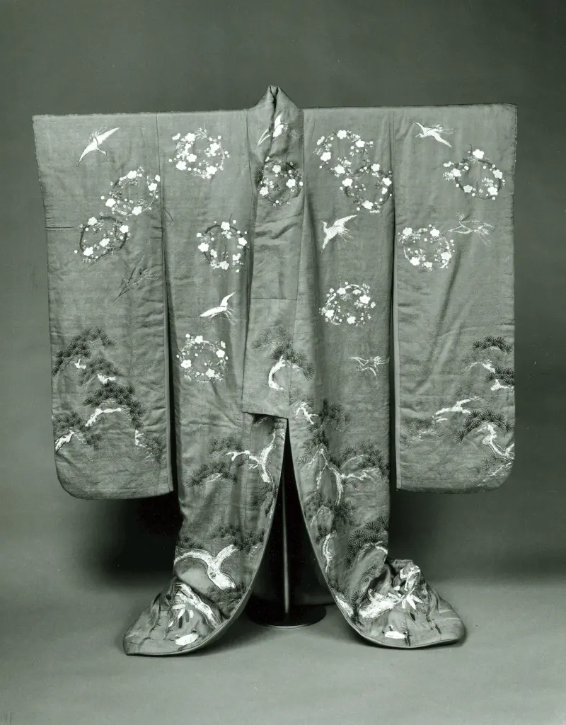 Front view of a red-orange nineteenth-century furisode with long sleeves and embroidered decoration