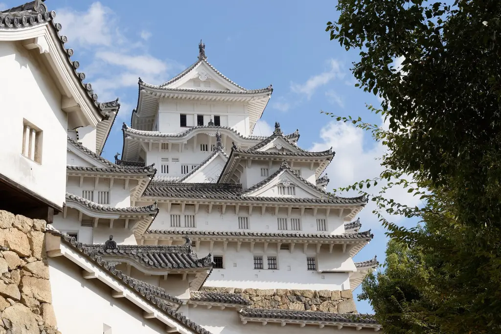 White-plastered towers and stone ramparts at Himeji Castle.