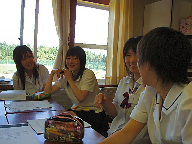 Japanese students seated around a table during a classroom group discussion