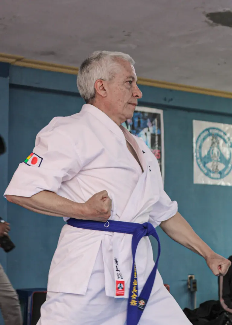 A Karate student practises a thrusting hand technique in a dojo
