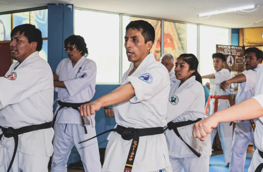 Karate practitioners coordinate posture and straight punches during kihon training
