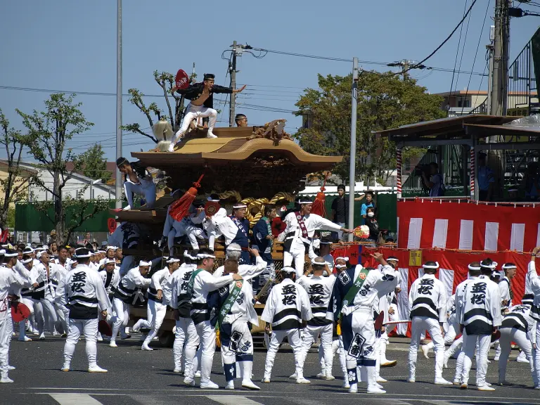Festival team guiding a carved wooden danjiri through a Kishiwada street