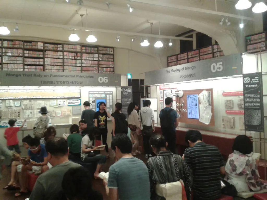Visitors and manga shelves in the main hall of Kyoto International Manga Museum