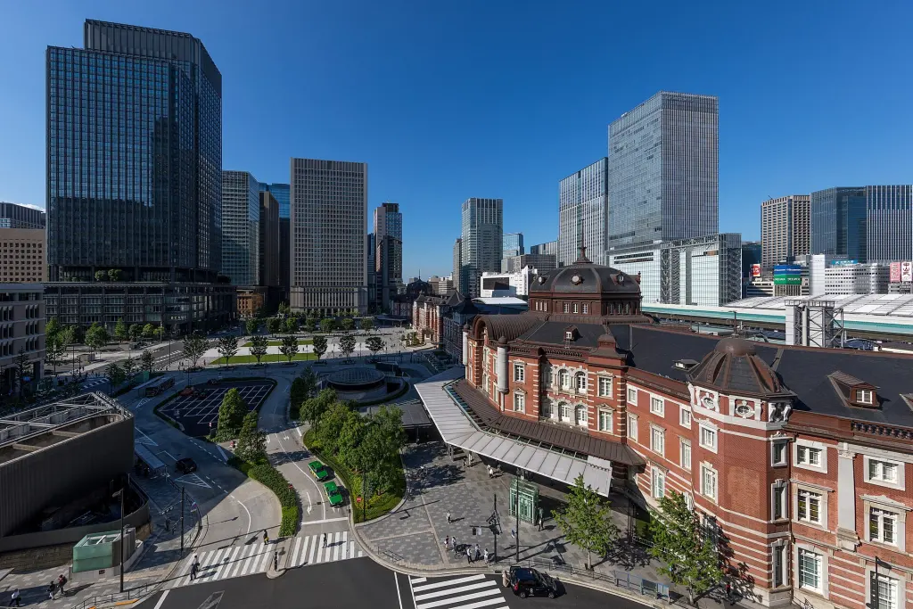 Red-brick Tokyo Station and Marunouchi plaza surrounded by modern office buildings