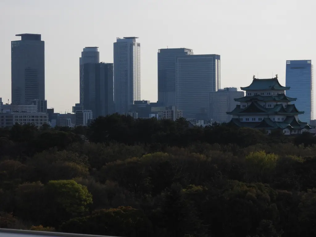 Nagoya Castle in the foreground with the towers around Nagoya Station in the distance