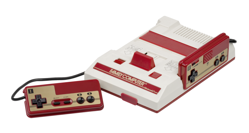 Nintendo Family Computer console and two red-and-gold controllers on a white background
