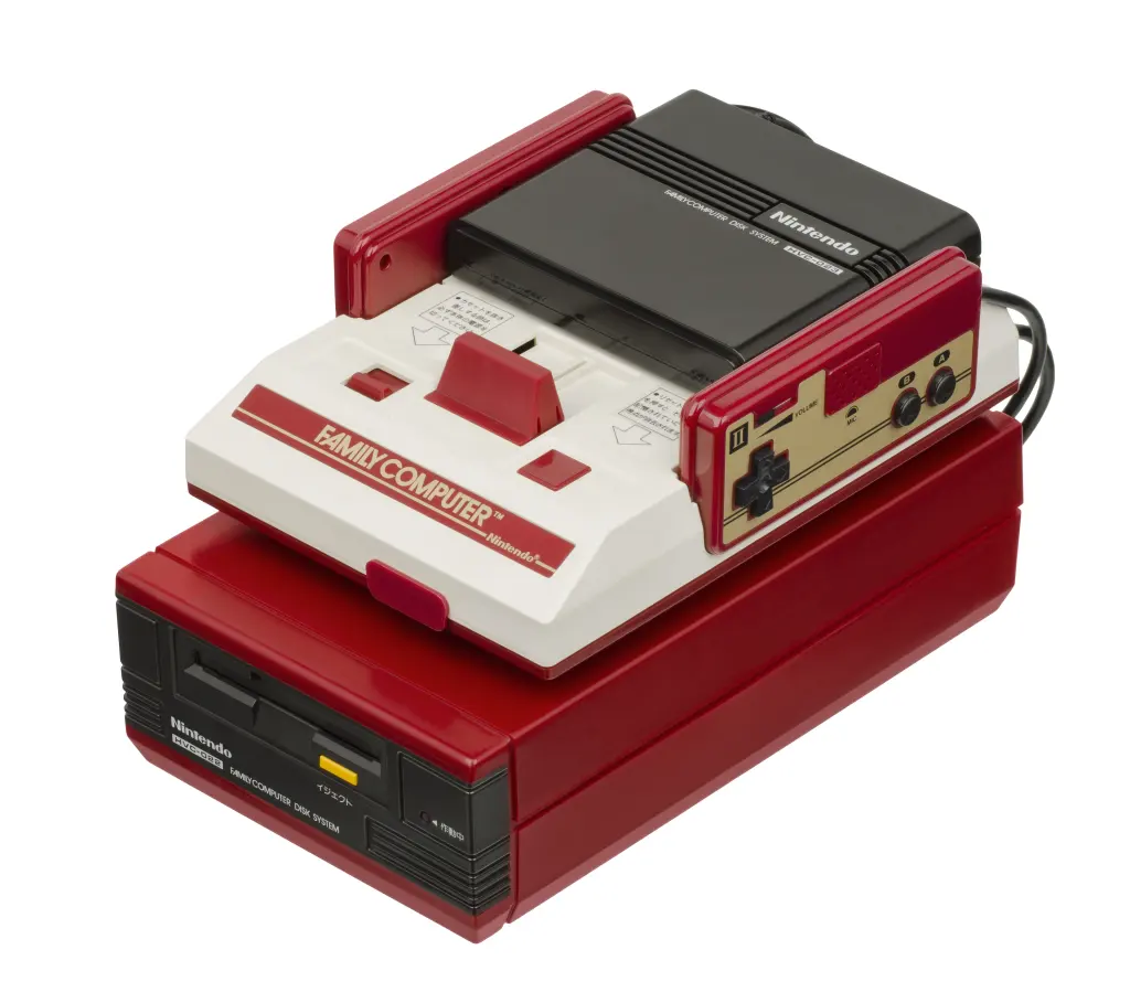 Red and white Nintendo Famicom console mounted on a Disk System unit.