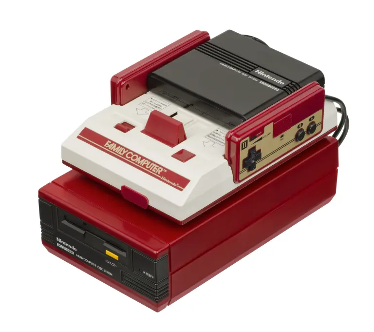 Red and white Nintendo Famicom console mounted on a Disk System unit.