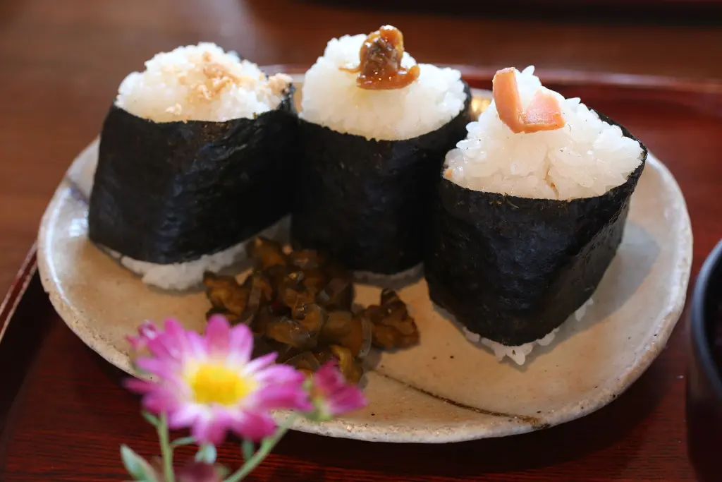 Plate of Japanese onigiri rice balls with nori and side dishes