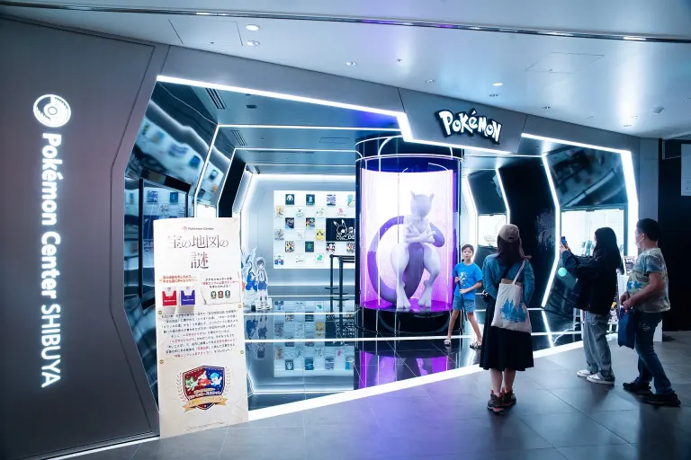 Visitors among colorful Pokémon character displays inside Pokémon Center Shibuya