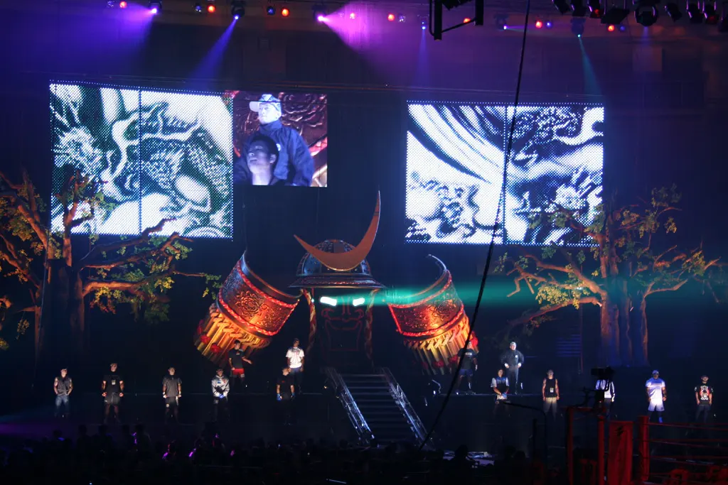 Fighters and officials stand in a brightly lit PRIDE Fighting Championships ring during an introduction