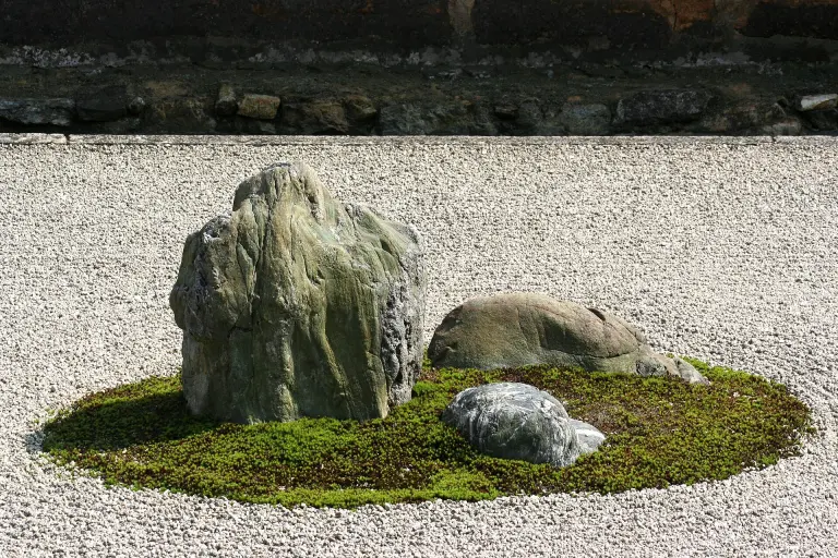 Stone groups surrounded by raked gravel in Ryōanji's karesansui garden