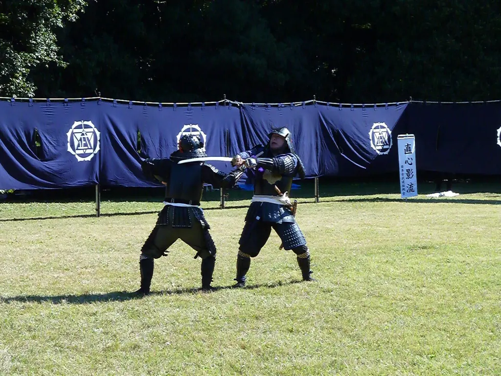 Two practitioners demonstrate a classical Japanese martial-art technique at Meiji Jingu