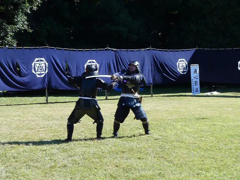 Two practitioners demonstrate a classical Japanese martial-art technique at Meiji Jingu