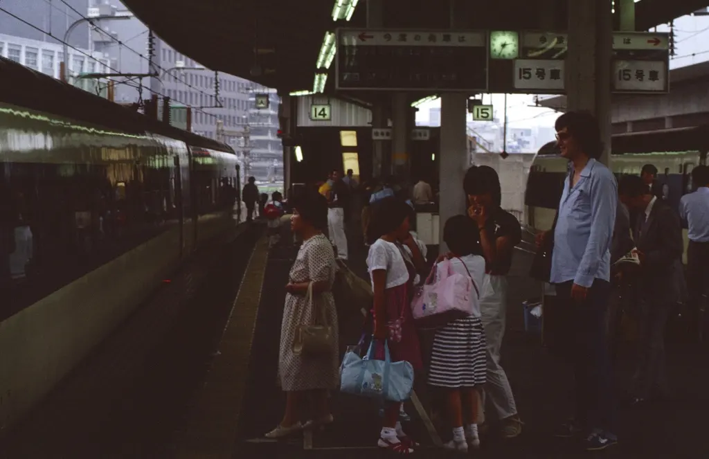 Passengers queue at marked door positions on a Shinkansen platform at Tokyo Station