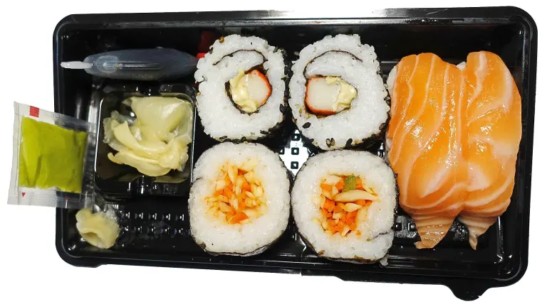 Assorted nigiri and rolled sushi served with soy sauce, pickled ginger, and wasabi