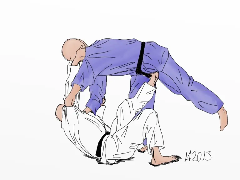 Two judoka demonstrate tomoe-nage on a mat