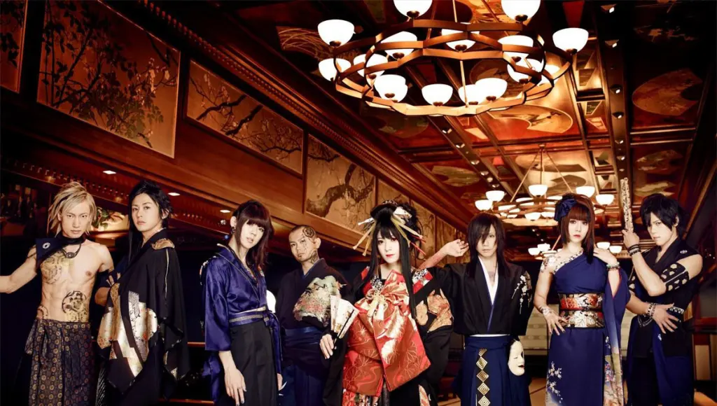 The eight members of Wagakki Band pose in elaborate stage costumes inside a richly decorated interior