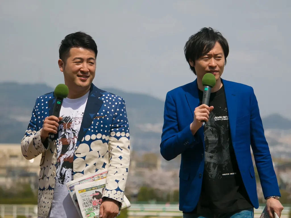 The two members of Wagyu performing together at a microphone