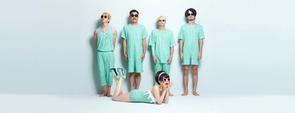 The five members of Tokyo Incidents pose in coordinated pale green outfits against a light studio wall