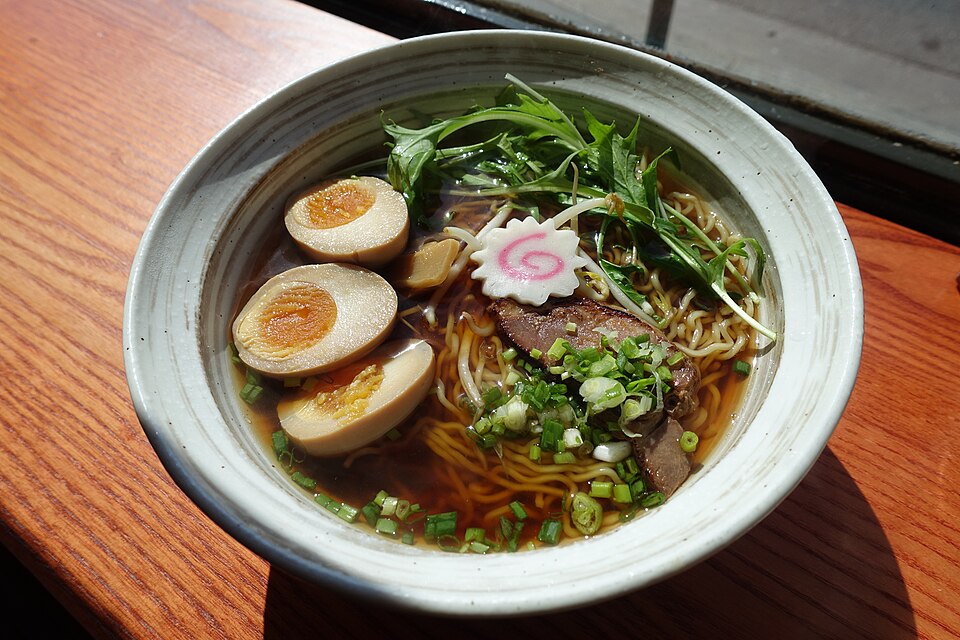 A bowl of shoyu ramen with eggs and sliced meat