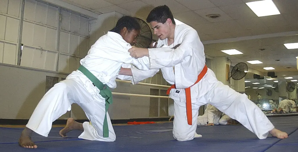 Two practitioners work from a grounded position during Judo practice