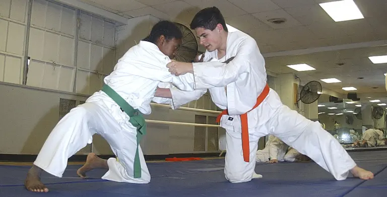 Two practitioners work from a grounded position during Judo practice